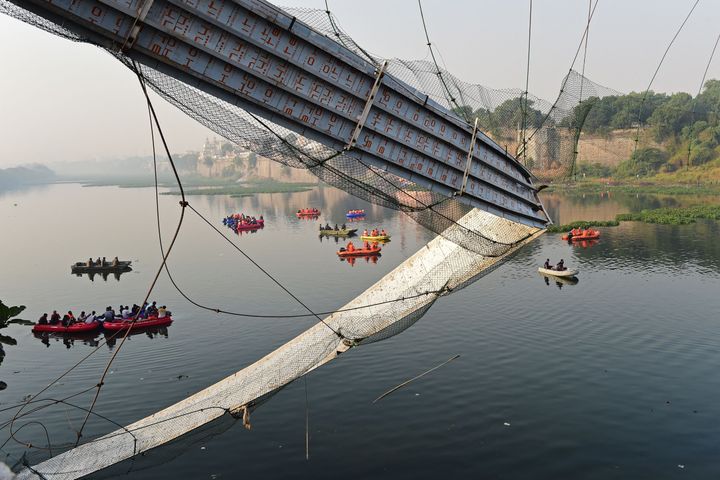 Rescue personnel conduct search operations after a bridge across the river Machchhu collapsed at Morbi in India's Gujarat state on October 31, 2022.