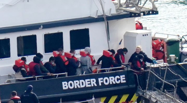 A group of people thought to be migrants are brought in to Dover, Kent, in October.