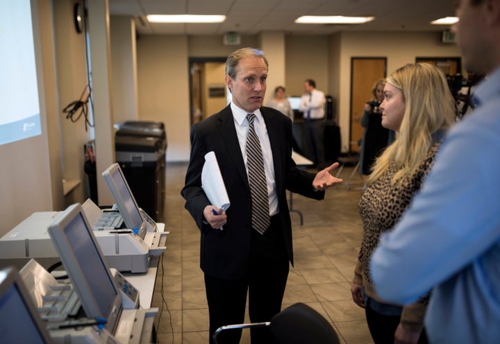 Minnesota Secretary of State Steve Simon (L) speaks with city clerk Melissa Kennedy (C) and election specialist Robert Stokka (R) during a public accuracy test of Election Day voting machines at the Municipal Services Center on Oct. 23, 2018 in St. Louis Park, outside Minneapolis, Minnesota.