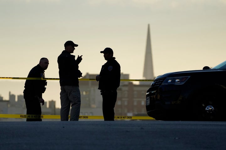 Police stand at the top of the closed street outside the home of House Speaker Nancy Pelosi and her husband, Paul Pelosi, in San Francisco on Friday. Paul Pelosi, was severely beaten by an assailant who broke into their home.