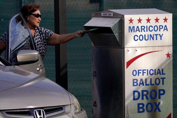 A voter casts their ballot at a secure ballot drop box at the Maricopa County Tabulation and Election Center in Phoenix, on Nov. 1, 2022. 