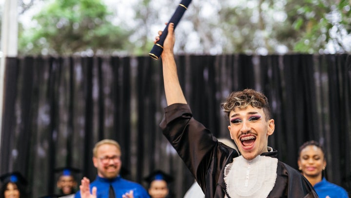 A stock photo from Getty of a nonbinary student graduating. 