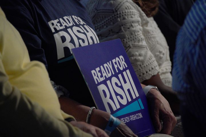 A Rishi Sunak supporter holds a placard inside Manchester Central Convention Complex during the Tory leadership contest in the summer.