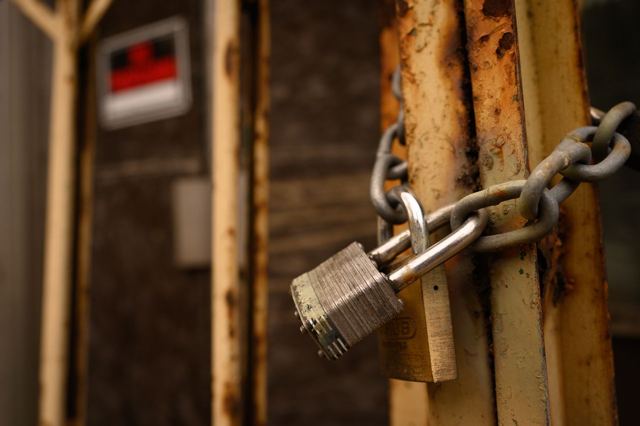 A padlock secures a door on a shuttered storefront in Braddock.