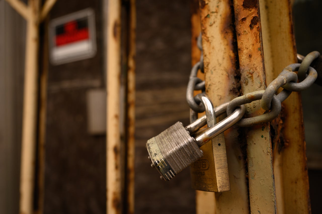 A padlock secures a door on a shuttered storefront in Braddock.