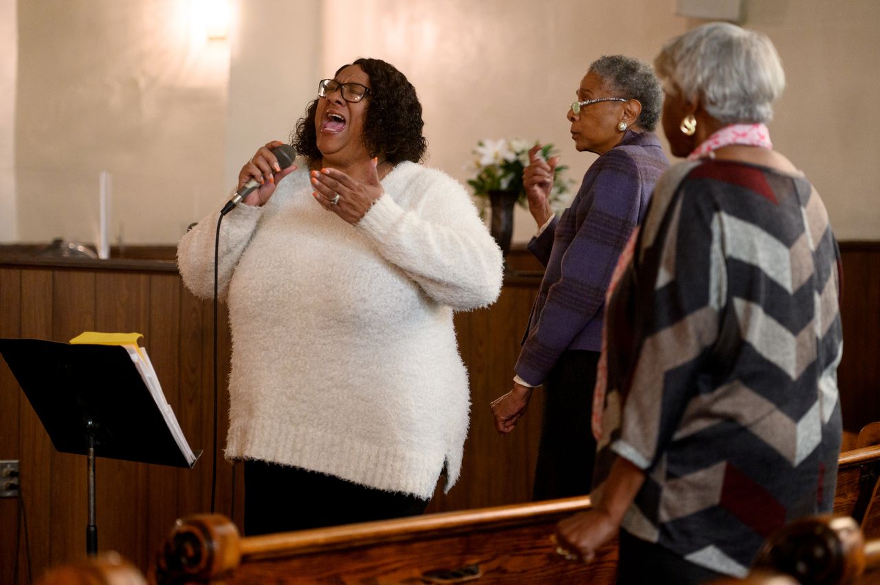 Lisa Baldwin sings during a service at Holliday Memorial AME Zion Church. She's Annette's daughter and Demetrius' mother.