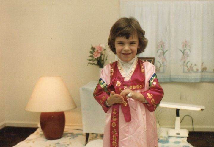 The author as a child participating in an "Eight Day Ceremony" for her brother, during which he was dedicated to God.