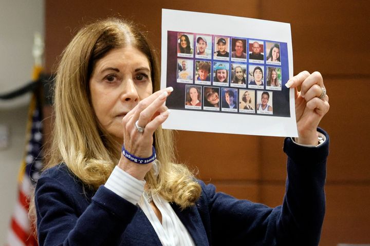 Linda Beigel Schulman displays a composite photo of the 17 murdered students and staff as she gives her victim impact statement during the sentencing hearing for Marjory Stoneman Douglas High School shooter Nikolas Cruz at the Broward County Courthouse in Fort Lauderdale, Fla., on Wednesday, Nov. 2, 2022. Beigel Schulman's son, Scott Beigel, was killed in the 2018 shootings. Cruz formally received a sentence of life without parole Wednesday after families of his 17 slain victims spent two days berating him as evil, a coward, a monster and a subhuman. (Amy Beth Bennett/South Florida Sun Sentinel via AP, Pool)