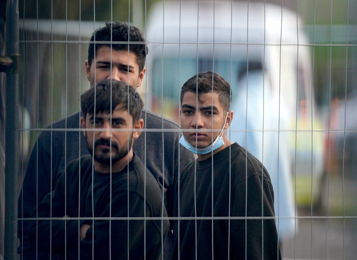 People thought to be migrants inside the Manston immigration short-term holding facility located at the former Defence Fire Training and Development Centre in Thanet, Kent