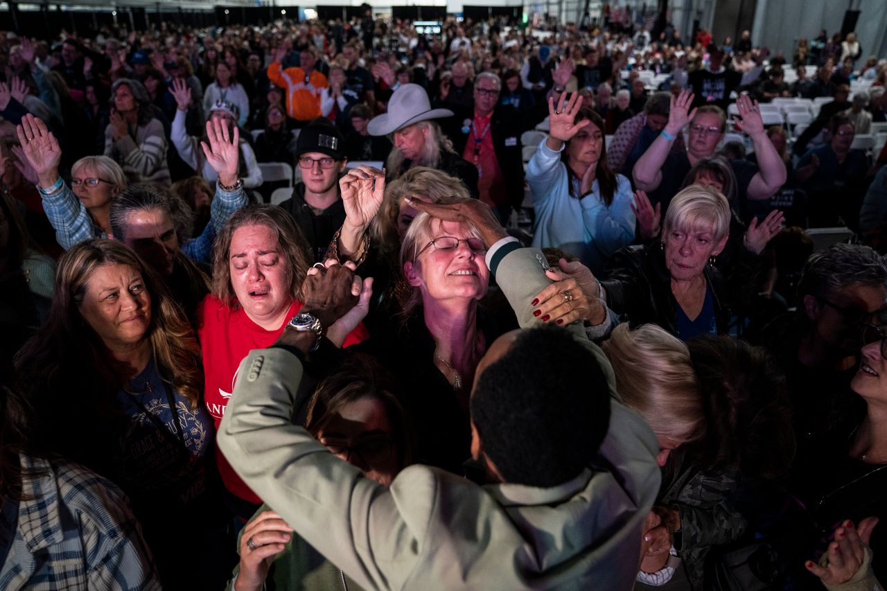 Attendees are prayed over during a worship and prayer time at the Great ReAwakening America Tour held at the Spooky Nook Sports Complex on Friday, Oct 21, 2022 in Manheim, Pennsylvania.