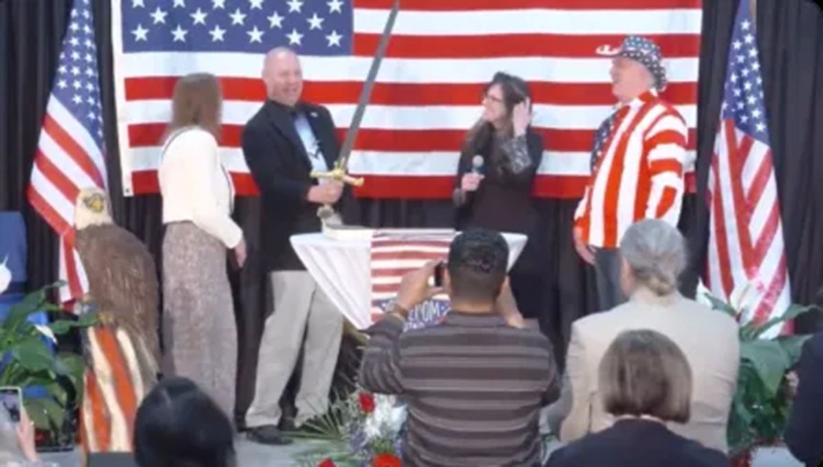 Doug Mastriano, GOP nominee for governor of Pennsylvania, holds a sword at an event hosted by QAnon conspiracy theorists in Gettysburg, Pennsylvania, in April 2022.