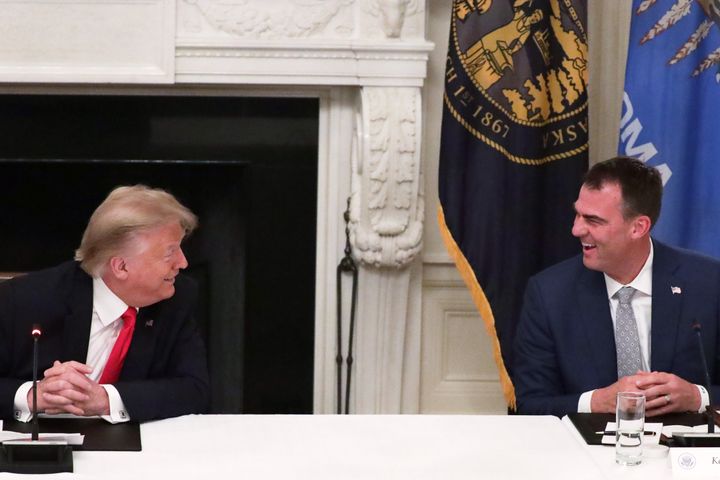 Oklahoma Gov. Kevin Stitt talks to former president Donald J. Trump in 2020 at the White House at a roundtable on reopening businesses during the coronavirus pandemic.