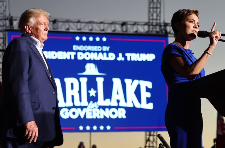 Former US president Donald Trump looks on as Arizona Republican nominee for governor Kari Lake speaks during a campaign rally in Mesa.