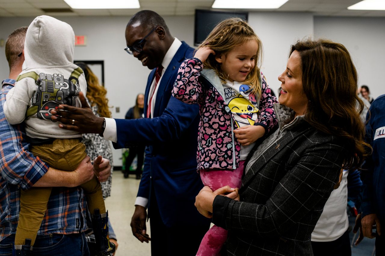 Whitmer holds 3-year-old Emmeline Miller, at the conclusion of a campaign event at the UAW Local 3000 offices in Woodhaven, Michigan, on Oct. 26.
