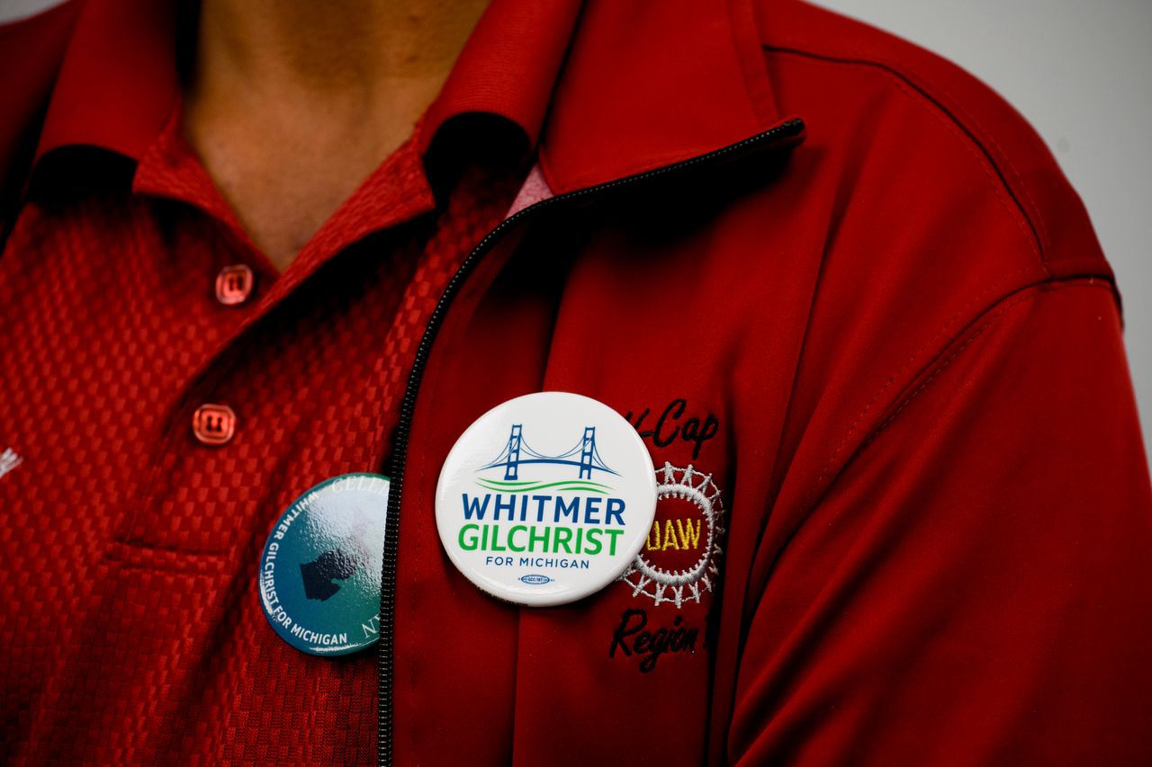 A UAW worker wears a pin in support of Whitmer during a campaign event at the UAW Local 3000 offices on Oct. 26.