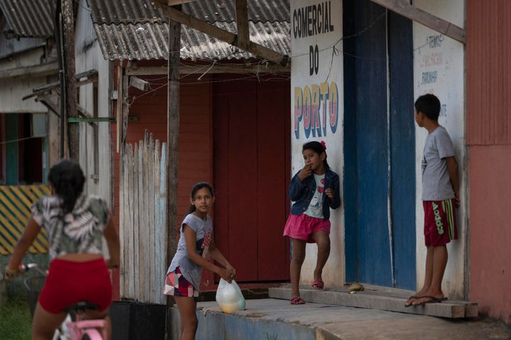 Children gather outside in Manicore, a city located on the banks of the Madeira and Manicore rivers in the Amazon rainforest in Brazil's Amazonas State, on June 6, 2022.