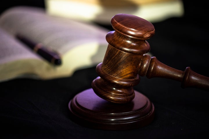 In this photo illustration a close up shot of judge banging the gavel for silence at court