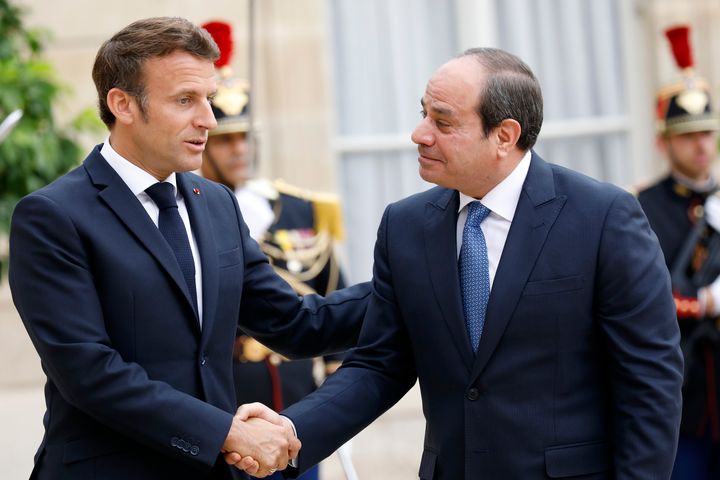 French President Emmanuel Macron shakes hands with Egyptian President Abdel Fattah al-Sisi (R) upon his arrival at the Elysee Palace in Paris on July 22, 2022.