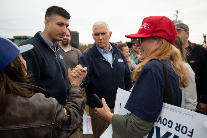 Former Vice President Mike Pence (center) campaigns with Michigan Republican congressional candidate Tom Barrett (left) at a rally on Nov. 4 in Charlotte, Michigan.