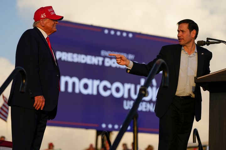 Sen. Marco Rubio (R-Fla.) speaks as former President Donald Trump listens at a campaign rally at the Miami-Dade County Fair and Exposition on Nov. 6, 2022. 