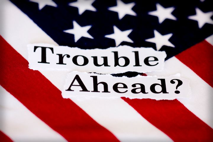 An American flag with the words trouble ahead