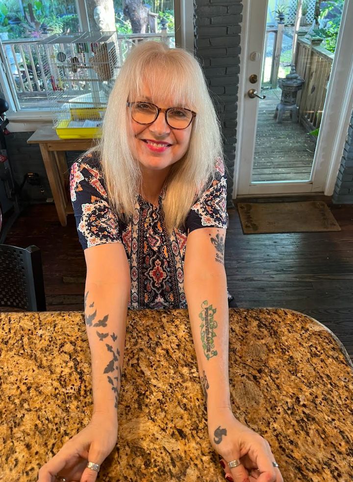 The author showing off some of her nine tattoos.