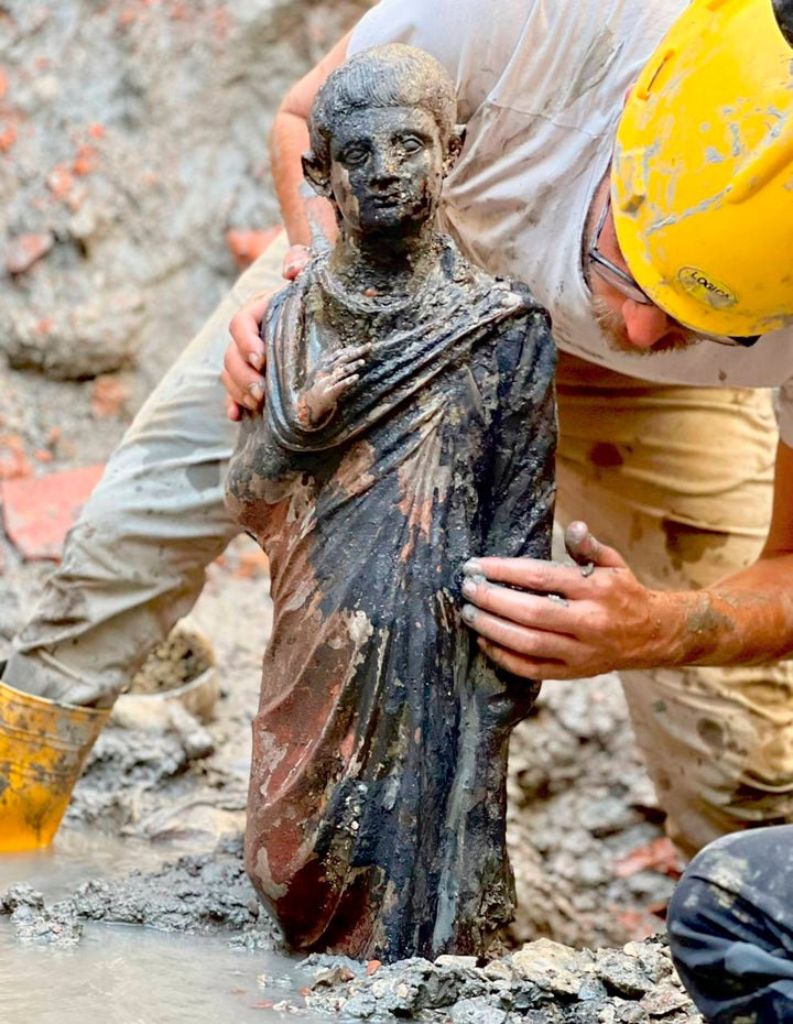 Archaeologists work at the site of the discovery of two dozen well-preserved bronze statues from an ancient Tuscan thermal spring in San Casciano dei Bagni, central Italy. (Italian Culture Ministry via AP)