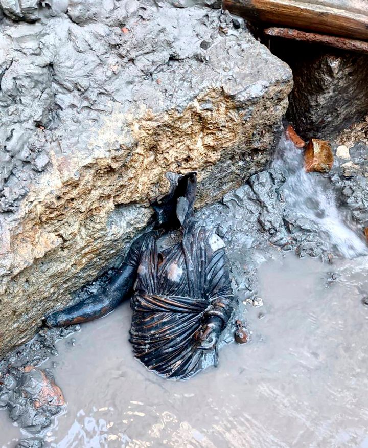 A statue is seen at the site of the discovery of two dozen well-preserved bronze statues from an ancient Tuscan thermal spring in San Casciano dei Bagni, central Italy. (Italian Culture Ministry via AP)