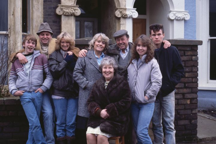 Original EastEnders cast members, including Gillian Taylforth and Bill Treacher, pose on the show's set