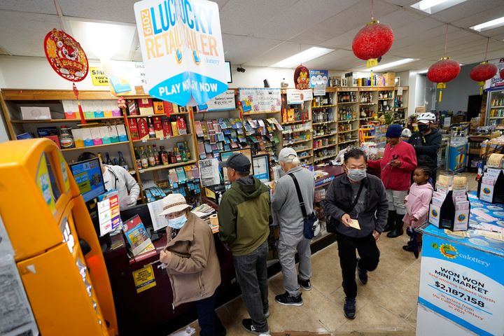 People stand in line to buy Powerball lottery tickets at the Wo Won Mini market in the Chinatown district of Los Angeles on Monday.