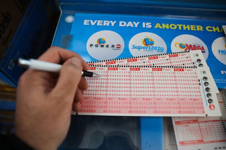 A person plays Powerball lottery at a 7-Eleven store in Milpitas, California, on Monday. The Powerball jackpot hit a record $2.05 billion.