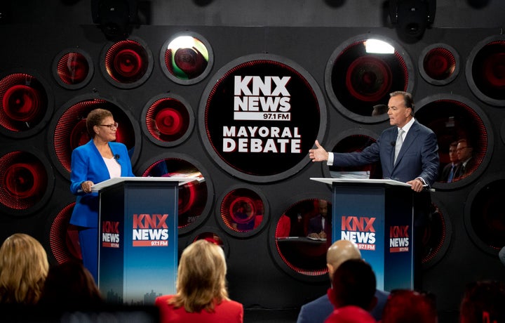 Caruso, right, speaks as Bass listens during a debate in Los Angeles on Oct. 6.