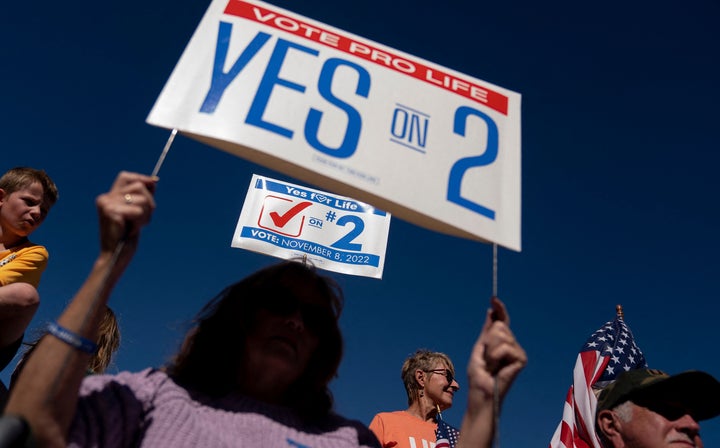 Demonstrators hold signs during a rally encouraging voters to vote yes on Amendment 2, which would add a permanent abortion ban to Kentuckys state constitution.