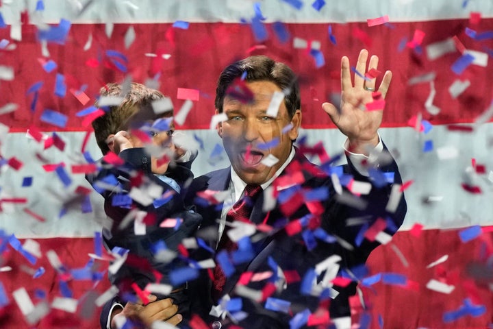 Incumbent Florida Republican governor Ron DeSantis holds his son Mason as he celebrates winning reelection in Tampa.