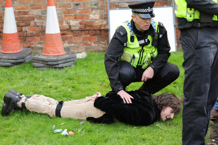  A member of the public is arrested by Police after throwing an egg as King Charles III and Camilla, Queen Consort