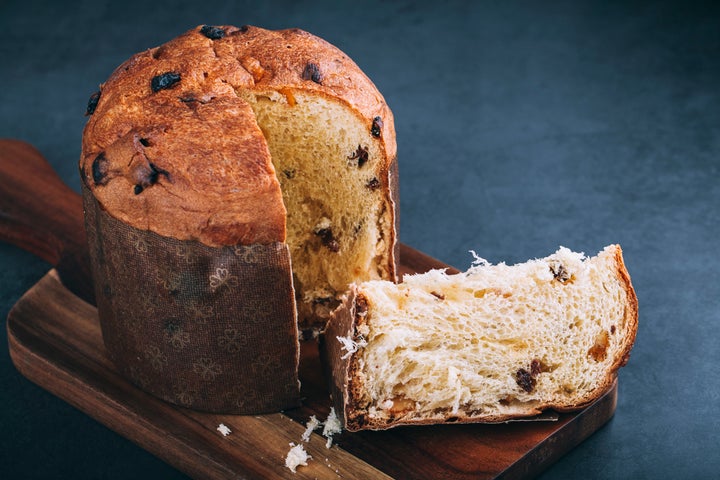 Italian Panettone fruit cake on black background