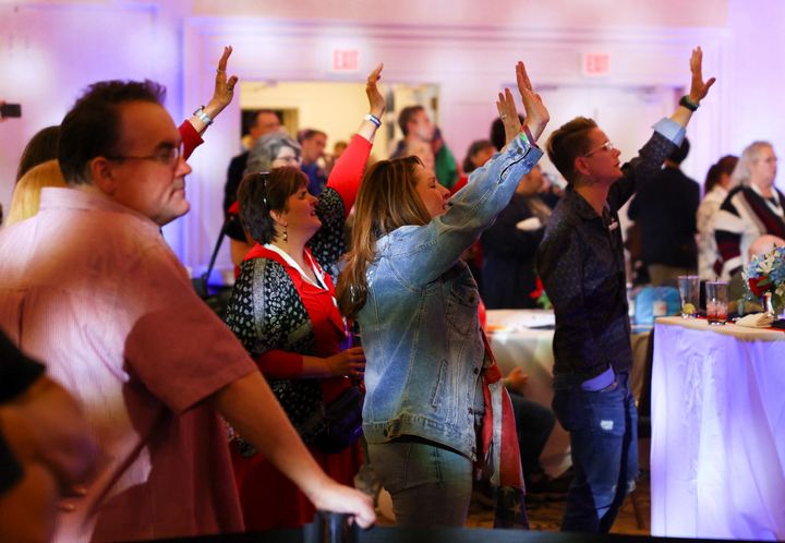 Supporters pray as they attend Republican candidate for Governor of Pennsylvania Doug Mastriano's 2022 U.S. midterm election night party, in Harrisburg, Pennsylvania, Nov. 8, 2022.