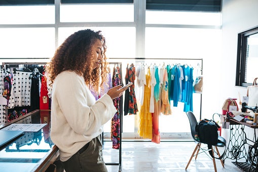 Woman working as salesperson in a retail clothing store.