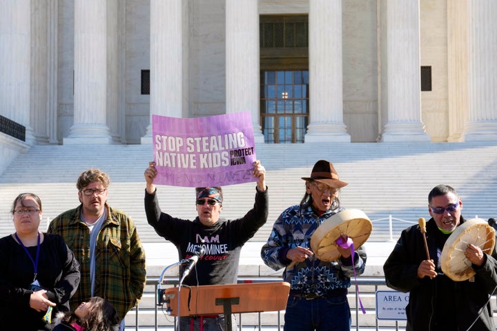 Demonstrators stand outside of the Supreme Court on Wednesday.
