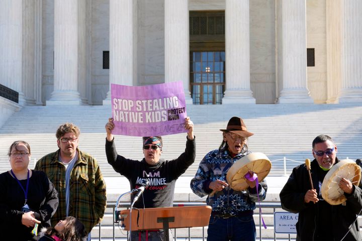 Demonstrators stand outside of the Supreme Court on Wednesday.