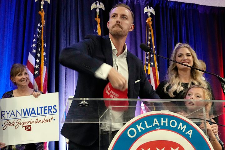 Ryan Walters, who won his race to be Oklahoma's next state school superintendent, throws a "Make America Great Again" cap to the crowd at a Republican election watch party Tuesday.