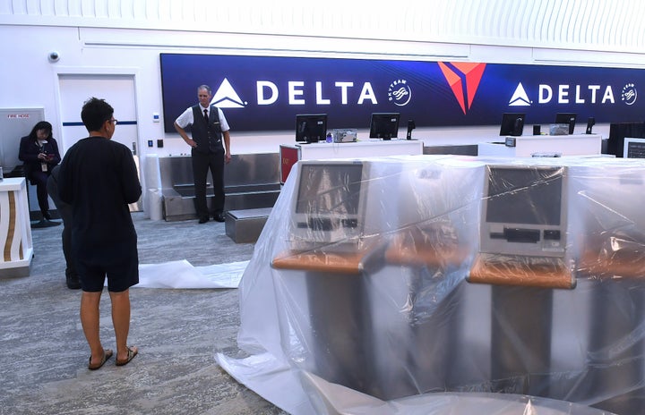 Passenger check-in kiosks are covered in protective plastic at Daytona Beach International Airport in Daytona Beach, Florida, on Wednesday. The airport was closed as Tropical Storm Nicole approached the coast.