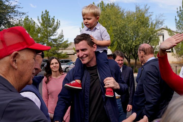 Republican U.S. Senate candidate Blake Masters holds his son, Rex, 2, as he speaks with supporters, Monday, Nov. 7, 2022, in Gilbert, Ariz. (AP Photo/Matt York)