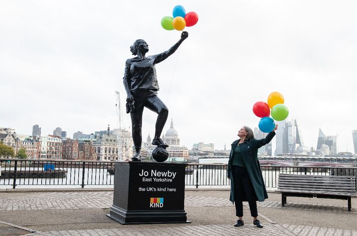 Jo Newby pictured with a statue of herself after being crowned the UK's kind hero.