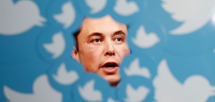 Twitter owner Elon Musk is seen surrounded by Twitter logos in a photo illustration.