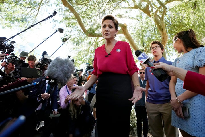 Kari Lake, Arizona Republican candidate for governor, speaks to the media after voting on Election Day with son Leo, second from right, and daughter Ruby, right, in Phoenix. On Thursday, Lake accused election workers of trying to undermine her campaign.