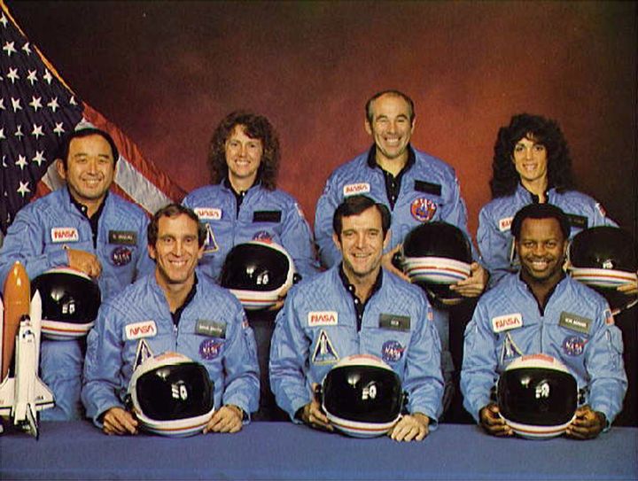 Space Shuttle Challenger crew members (back, L-R) Mission Specialist Ellison S. Onizuka, Teacher-in-Space participant Sharon Christa McAuliffe, Payload Specialist Greg Jarvis and mission specialist Judy Resnick. (Front, L-R) Pilot Mike Smith, commander Dick Scobee and mission specialist Ron McNair. 