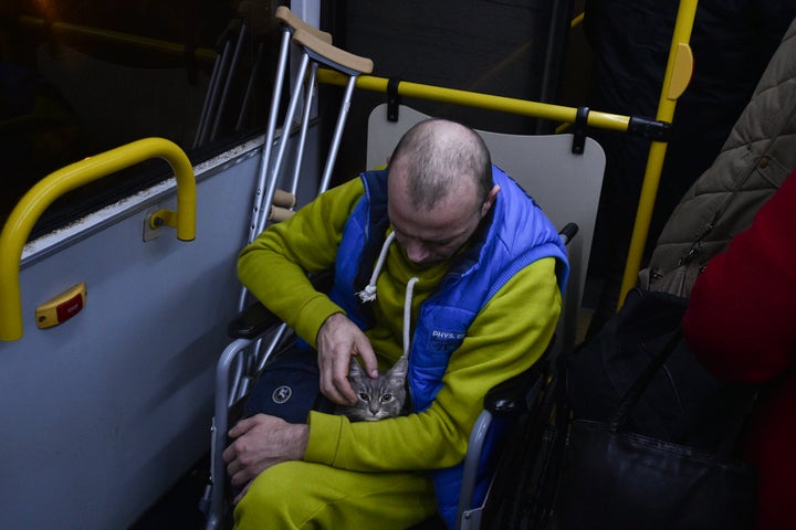 An evacuee from Kherson waits on a bus upon his arrival to Dzhankoi, Crimea, on Nov. 10, 2022. Russian Defense Minister Sergei Shoigu ordered a troop withdrawal from Kherson and nearby areas on Wednesday after his top general in Ukraine reported that a loss of supply routes during Ukraine's southern counteroffensive made a defense "futile." 