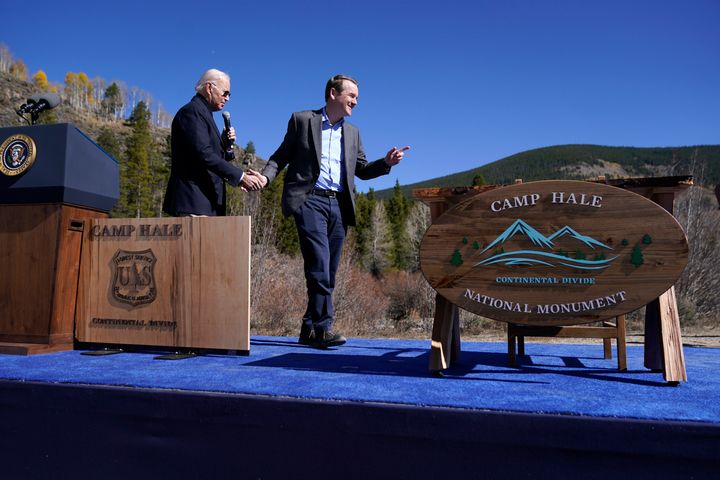 President Joe Biden shakes hands Oct. 12 with Sen. Michael Bennet (D-Colo.) as he speaks about protecting and conserving America's iconic lands at Camp Hale, near Leadville, Colorado.