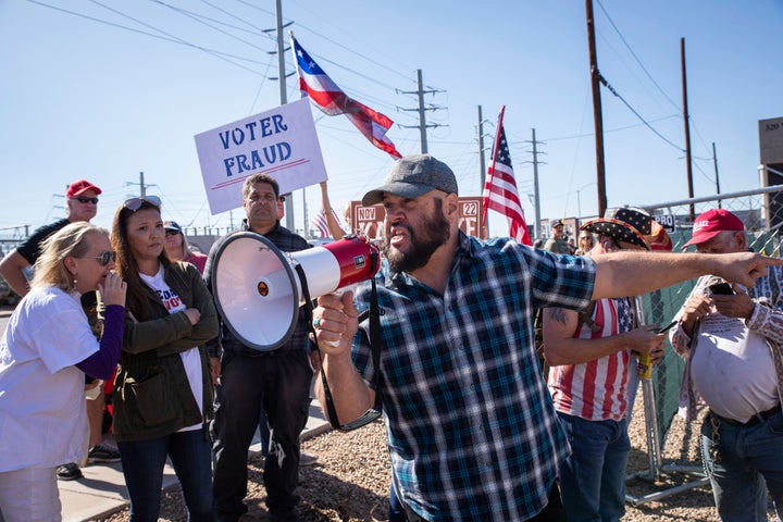 Republican supporters stand outside the Maricopa County Recorder's Office in Phoenix to protest what they allege is an unfair election.